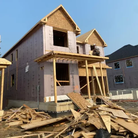Drywall mudding and taping being completed on interior walls for a smooth finish.