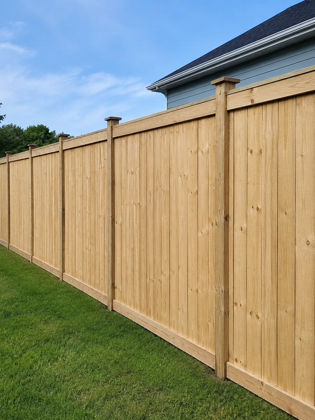 New privacy fence installed along a residential backyard for added seclusion and security.