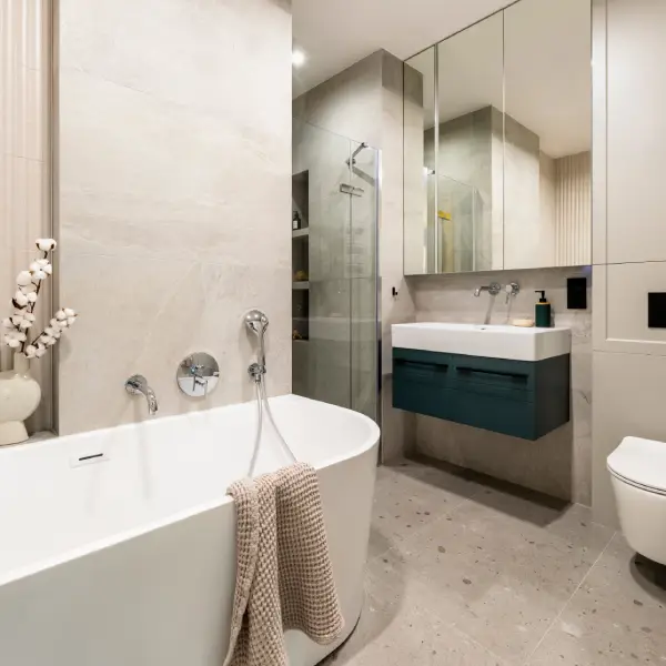 Renovated bathroom with tiled shower, modern vanity, and upgraded fixtures
