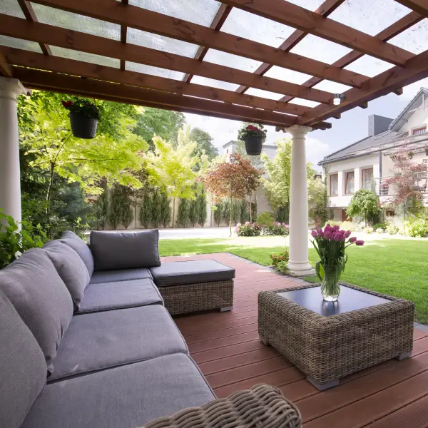 Composite deck with railing and outdoor seating in a backyard