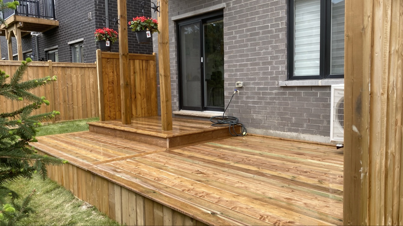 Cedar deck with pergola posts, hanging planters and privacy fence — Rouge Home Development Inc., GTA