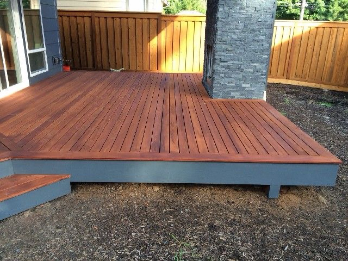 Ipe hardwood deck around an exterior chimney — Rouge Home Development Inc., GTA