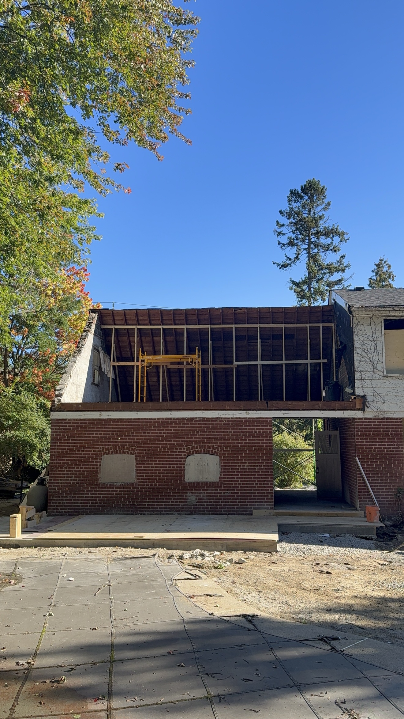 Second-floor addition framing in progress on a brick home — Rouge Home Development Inc., GTA