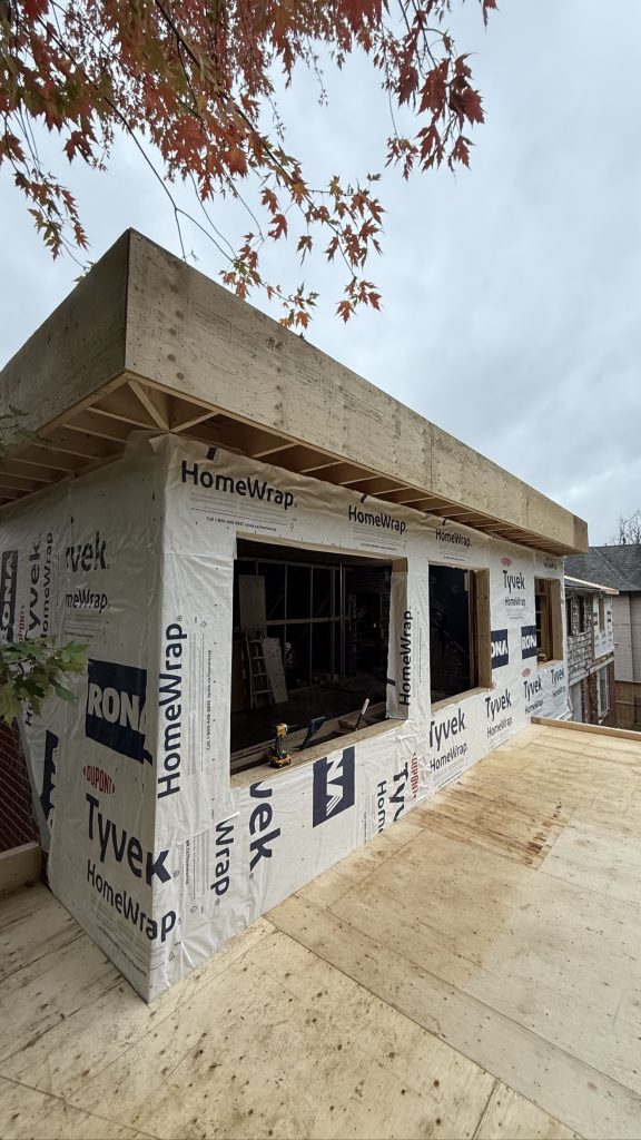 Tyvek-wrapped home addition with new roof structure — Rouge Home Development Inc., GTA framing