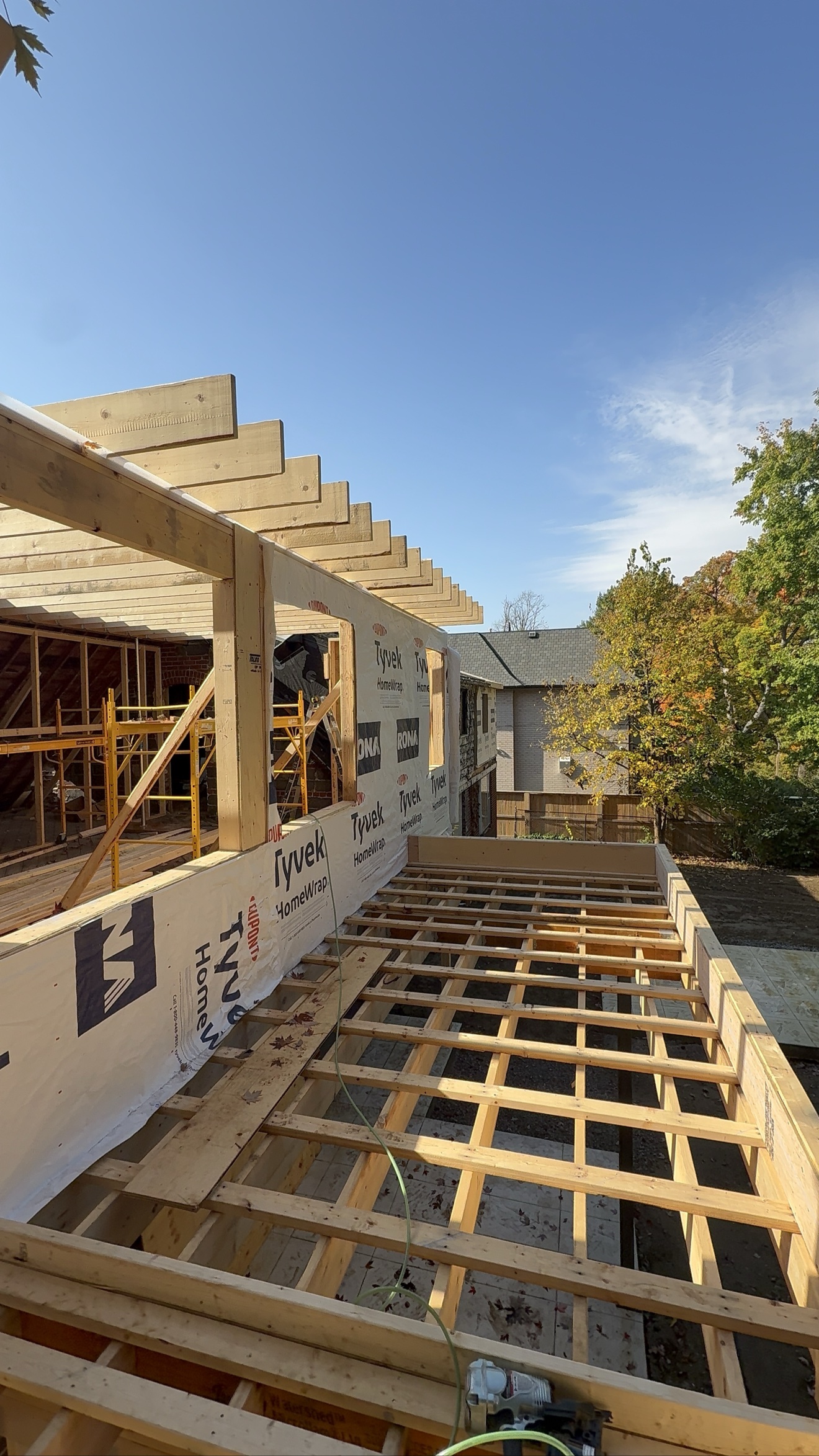 Interior view of framed floor structure with Tyvek wall — Rouge Home Development Inc., GTA home addition
