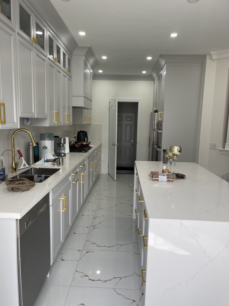 Kitchen renovation with large island and range hood — Rouge Home Development Inc., GTA