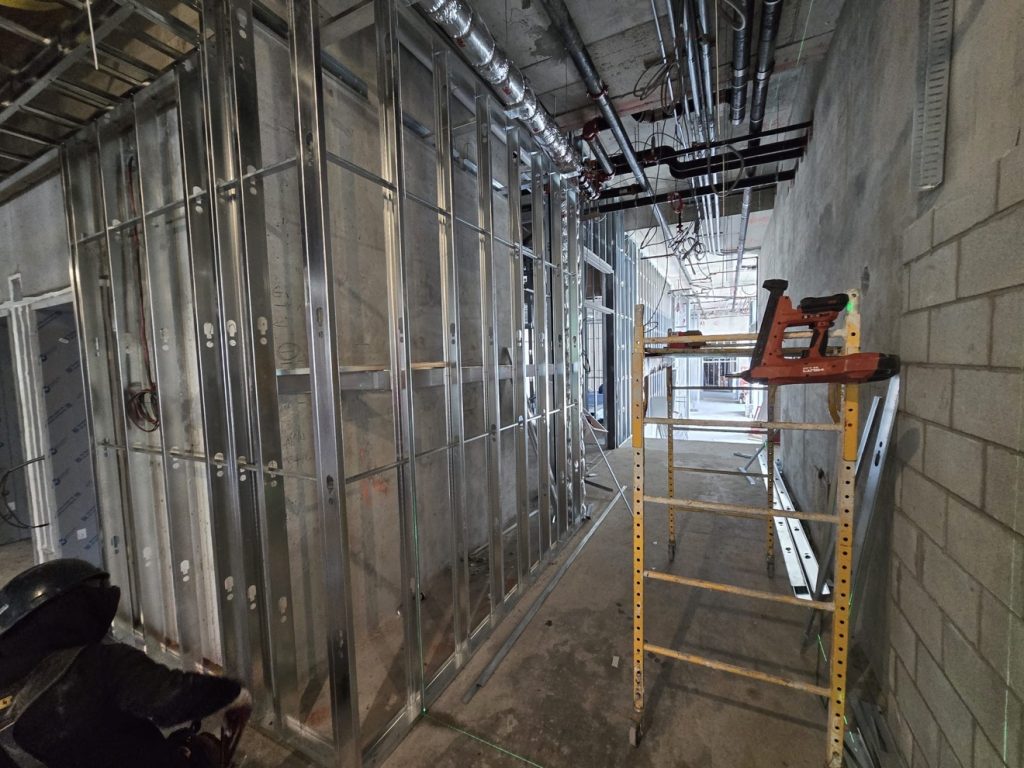 Corridor with steel stud framing and scaffold — Rouge Home Development Inc., GTA