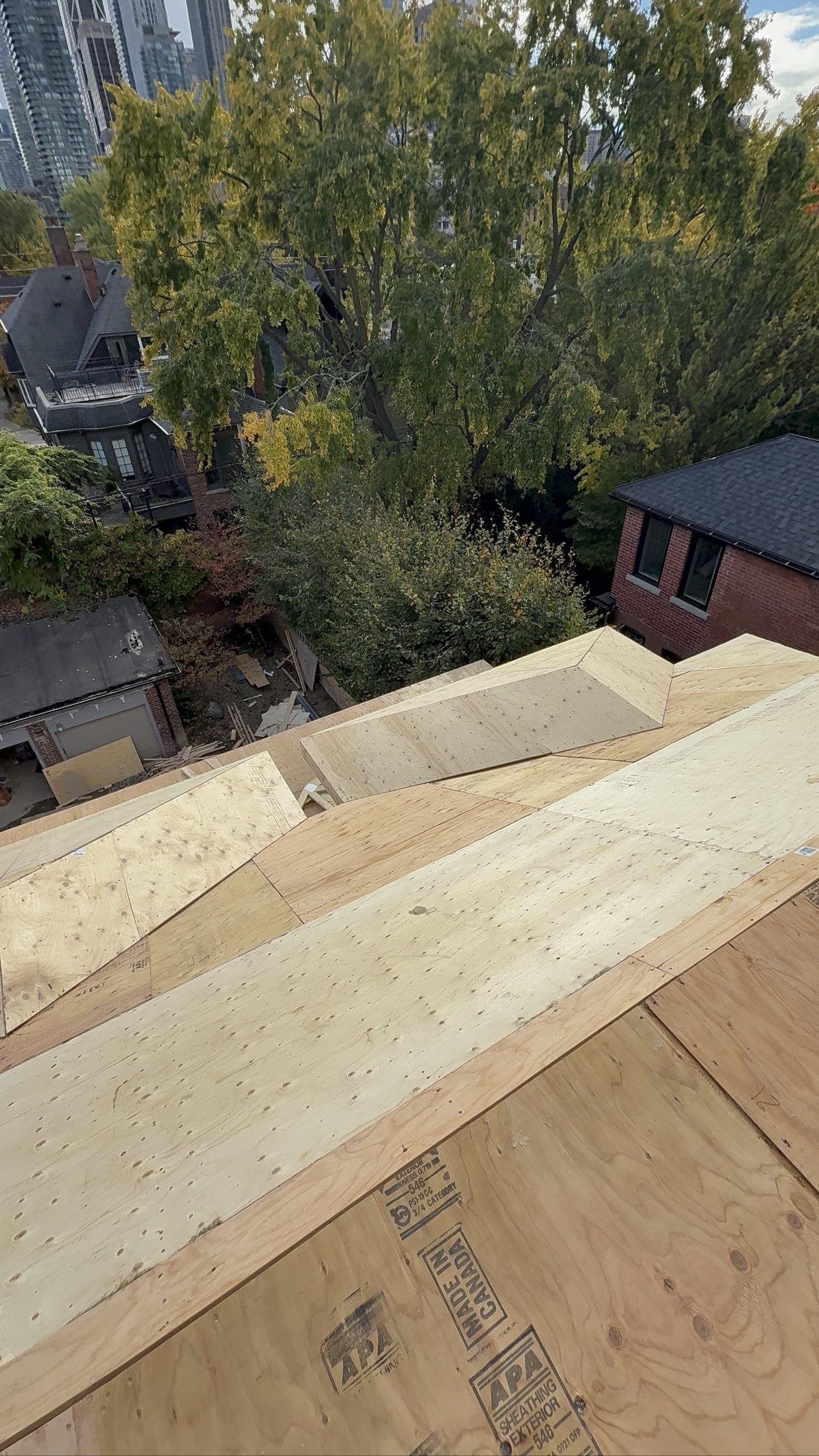 Framed house under construction at Roxborough St W and Yonge St Toronto